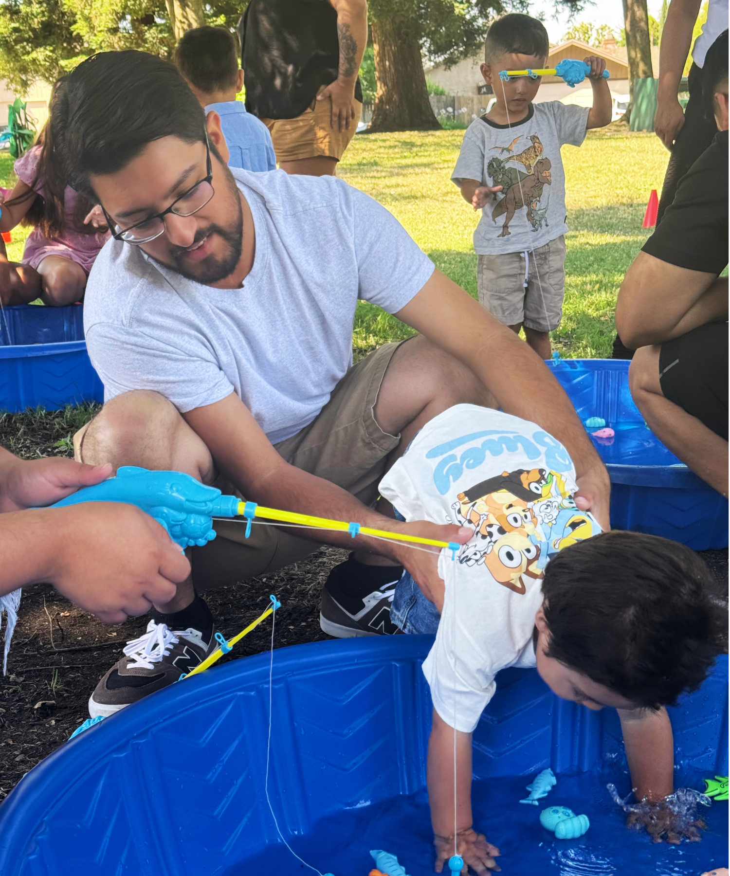 A father holds his son whose hands are in a small plastic poolr Celebrating Fathers YMCA of San Joaquin County August 21, 2024 6:00 p.m. - 8:00 p.m. Brookside County Club